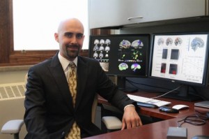 Iowa State University researcher Auriel Willette at computer screens showing brain scans. ISU photo by Blake Lanser.