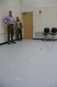 Matt Kramer and Ames Lab science writer Kerry Gibson look over the markings where the aberration-corrected STEM will be installed.