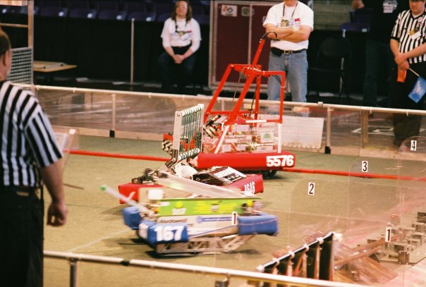 FRC robots mix it up on the playing field at Cedar Falls' McLeod Center.