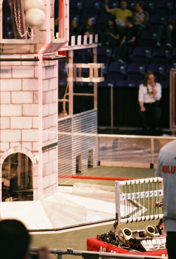 Sherman fires a boulder (upper left) into the blue alliance tower during FRC Iowa Regional competition at the University of Northern Iowa, Cedar Falls.