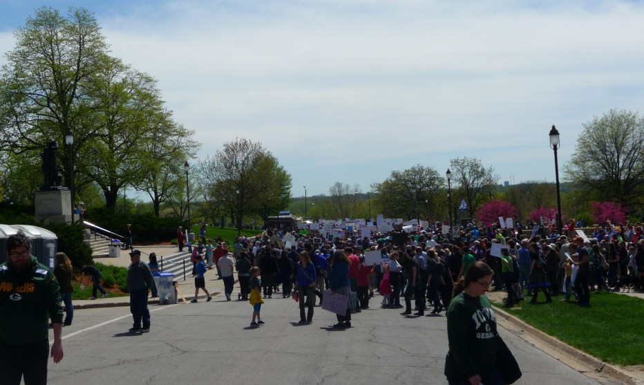A forest of signs sprouts as March for Science Iowa participants prepare to head south on Finkbine Drive. Credit: Paula Mohr.